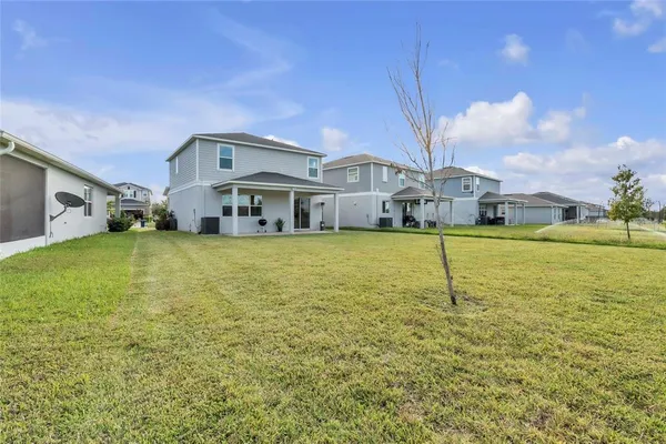 a house view with swimming pool in front of it