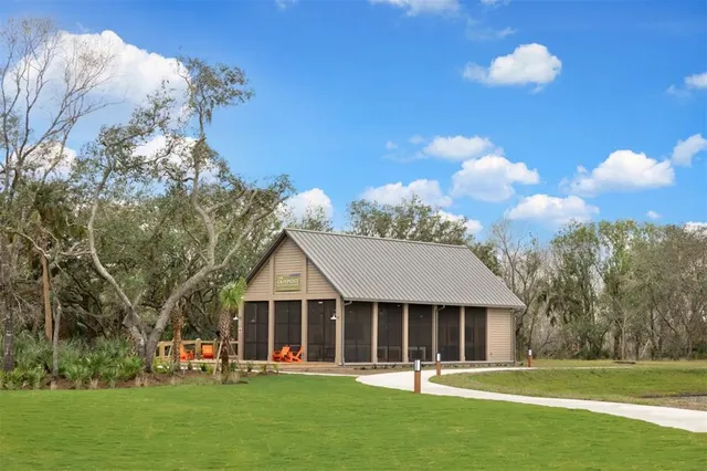 a front view of a house with a yard and trees