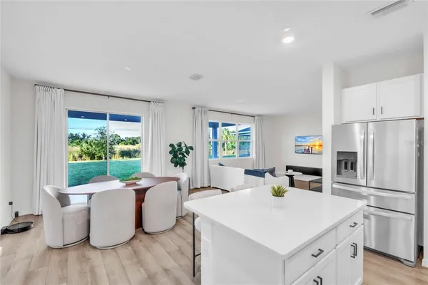 a kitchen with a stove a refrigerator and a dining table