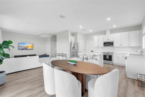 a large kitchen with a table and chairs
