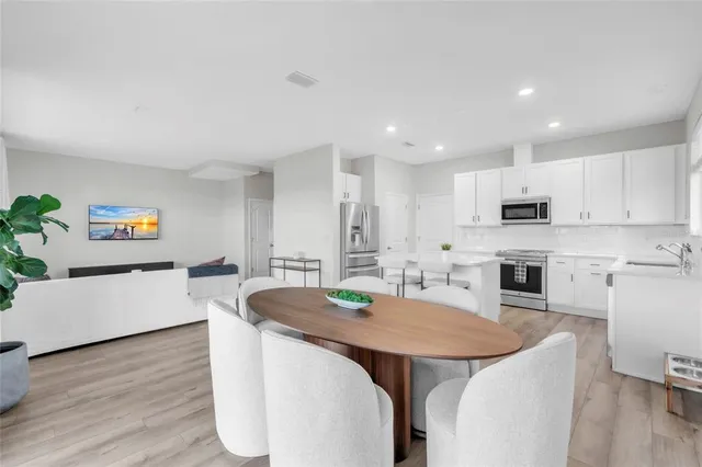 a large kitchen with a table and chairs