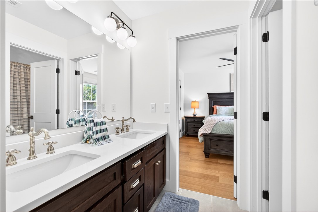 5016 Copeland Road Belton, SC 29627 - Photo 30 of 45 Double vanity with sleek hardware and bright lighting offers convenient access to an adjoining primary bedroom.