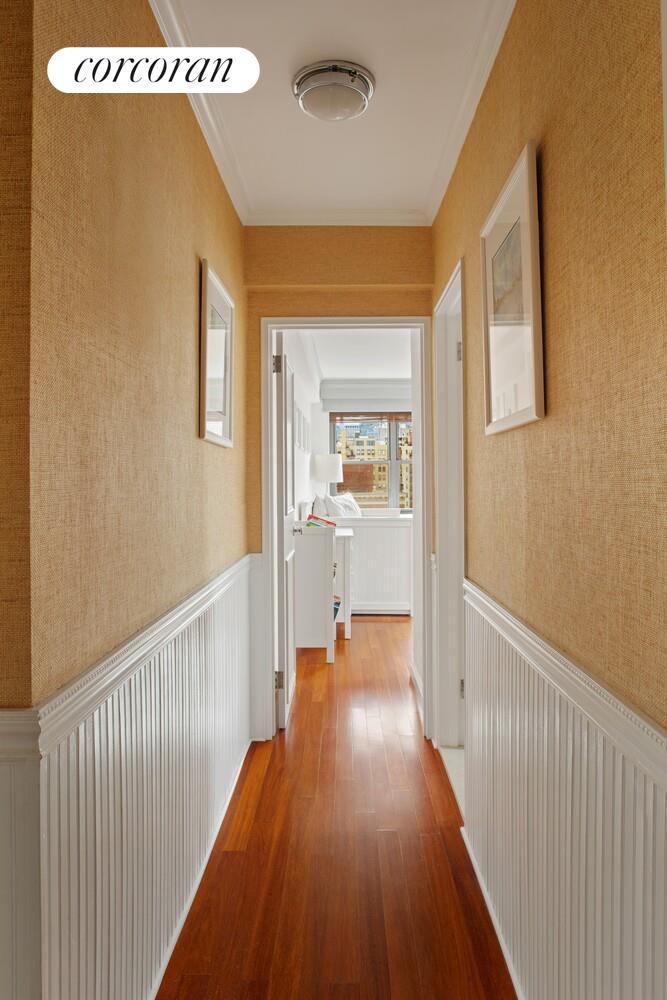 136 East 76th Street, Unit 15B Manhattan, NY 10021 - Photo 10 of 12 a view of a hallway with wooden floor