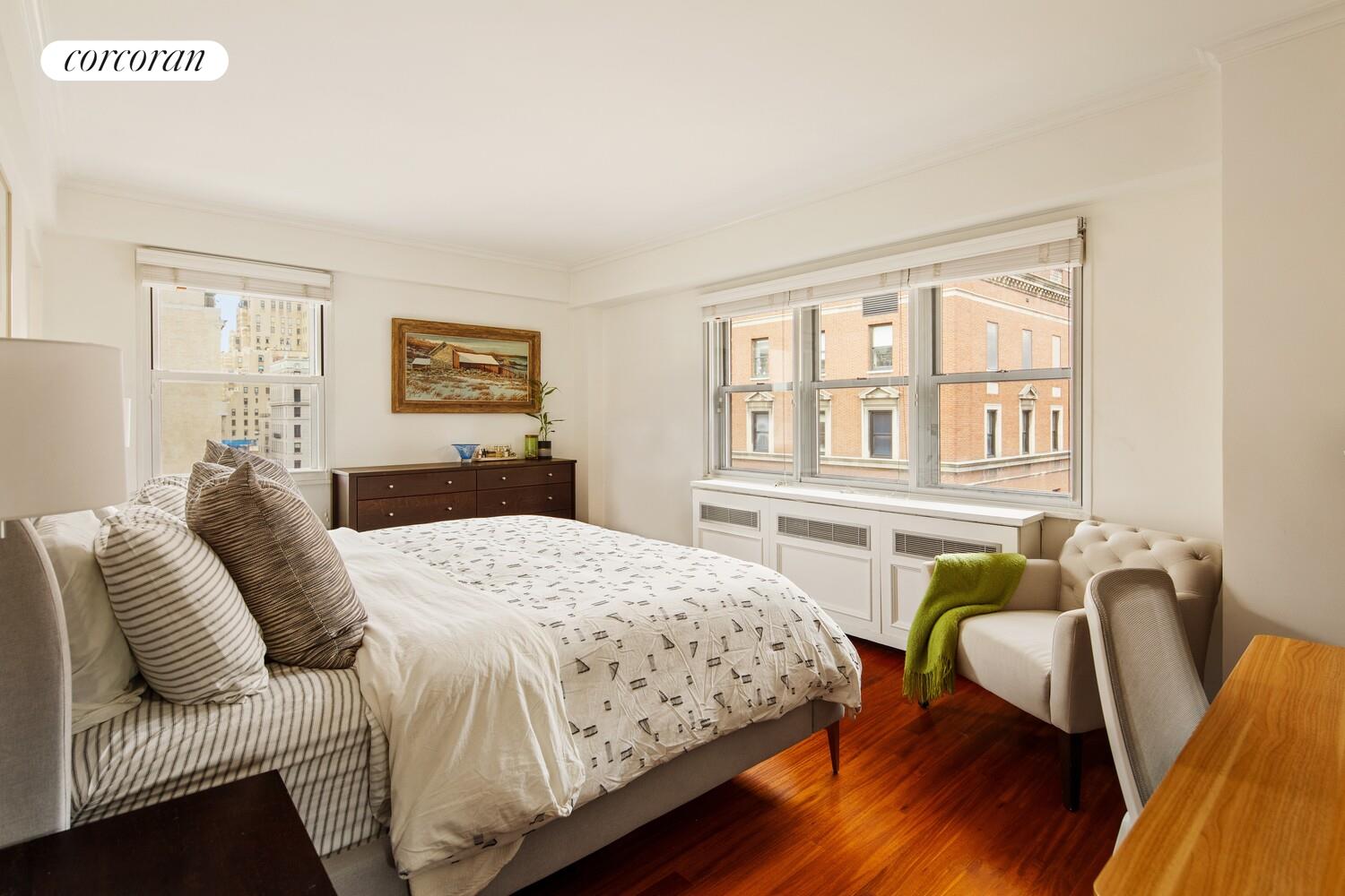 136 East 76th Street, Unit 15B Manhattan, NY 10021 - Photo 5 of 12 a bedroom with a bed and wooden floor