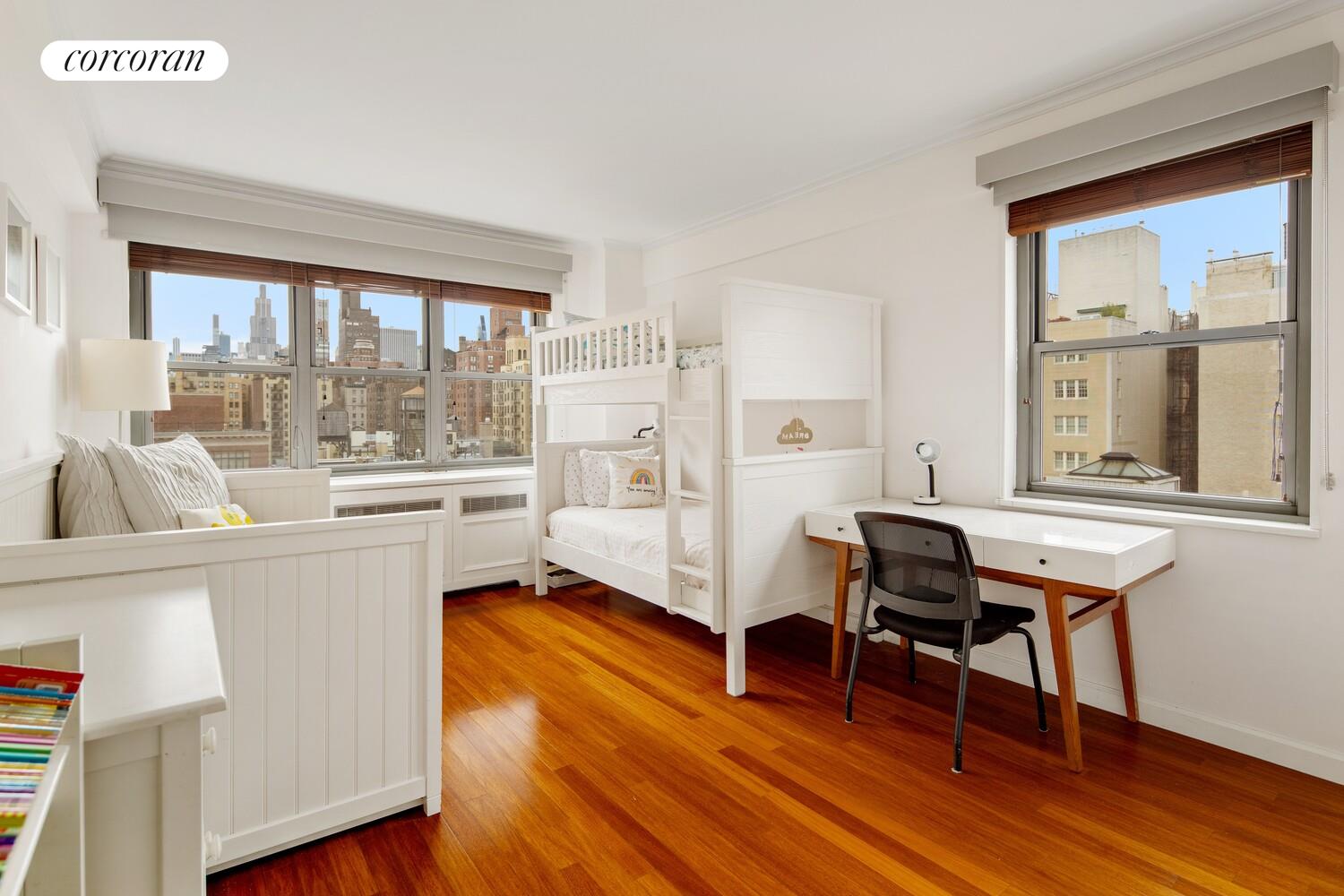 136 East 76th Street, Unit 15B Manhattan, NY 10021 - Photo 6 of 12 a living room with furniture a wooden floor and a large window