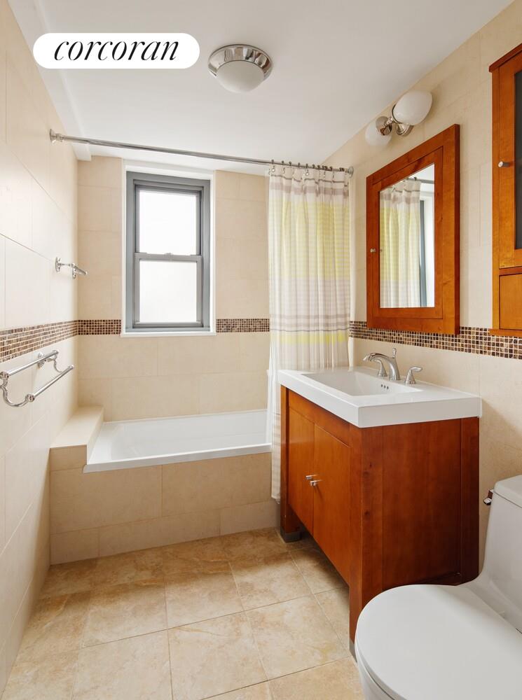 136 East 76th Street, Unit 15B Manhattan, NY 10021 - Photo 8 of 12 a bathroom with a tub sink and mirror