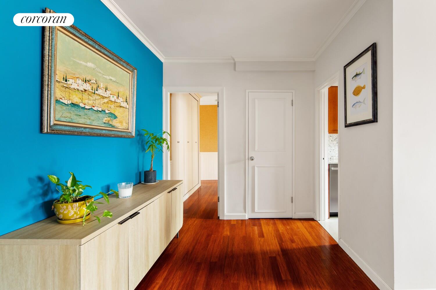 136 East 76th Street, Unit 15B Manhattan, NY 10021 - Photo 9 of 12 a hallway with toys and wooden floor