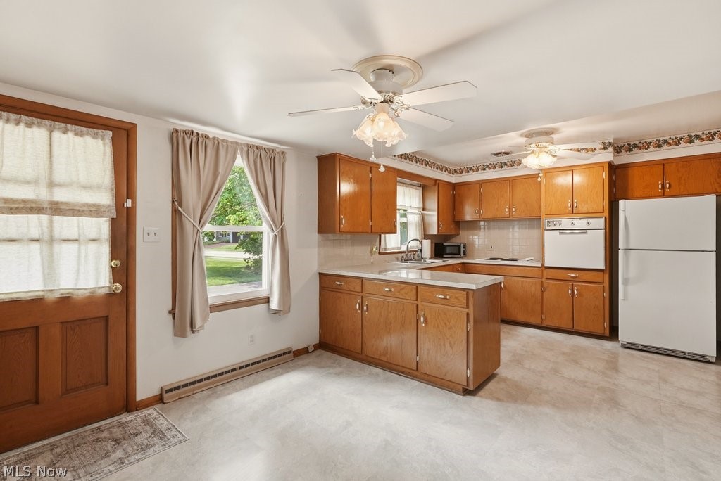 161 Pinehurst Road Munroe Falls, OH 44262 - Photo 9 of 40 Kitchen featuring wood cabinetry, white appliances, and light-toned flooring