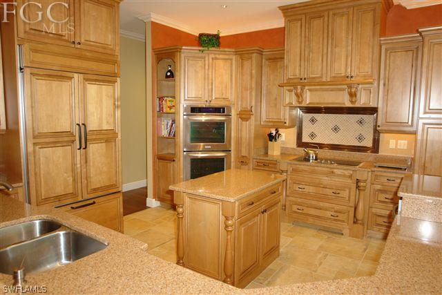 19010 Persimmon Ridge Road Alva, FL 33920 - Photo 6 of 24 a kitchen with stainless steel appliances granite countertop a sink a stove and a refrigerator with wooden floor