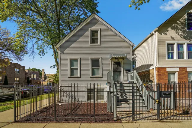 a view of a house with wooden fence