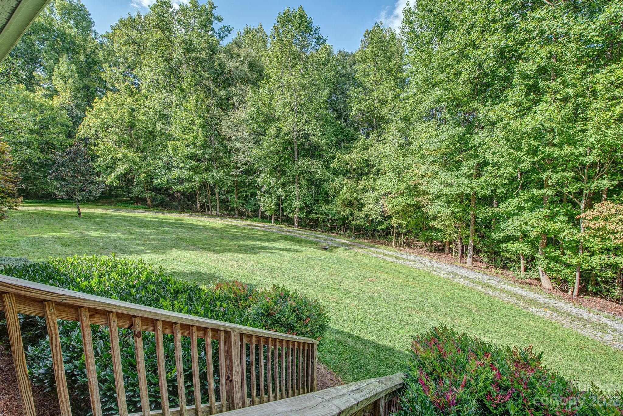 146 Flowers Road Gastonia, NC 28056 - Photo 3 of 11 a view of a green field with wooden fence