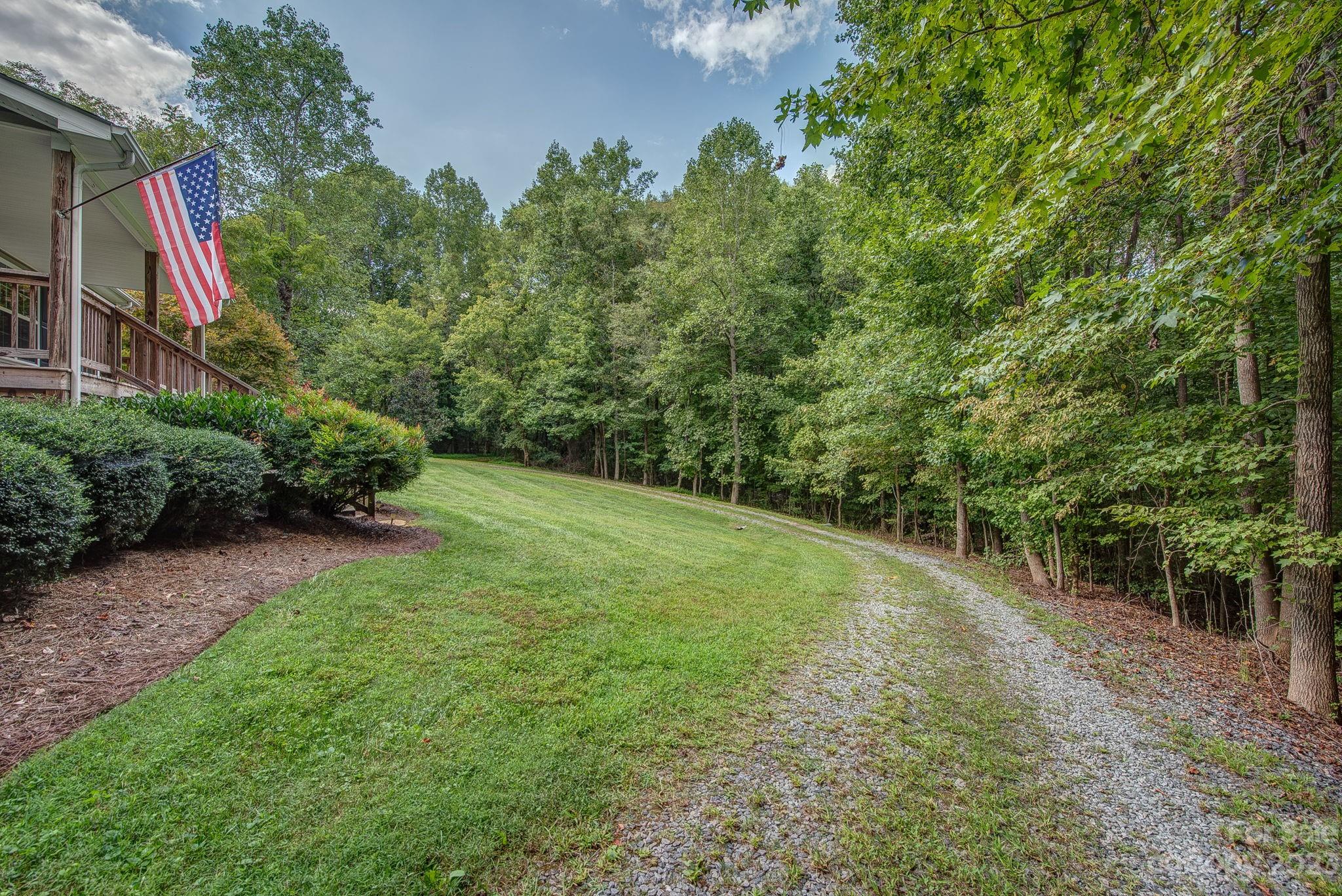 146 Flowers Road Gastonia, NC 28056 - Photo 4 of 11 a big yard with lots of green space and plants