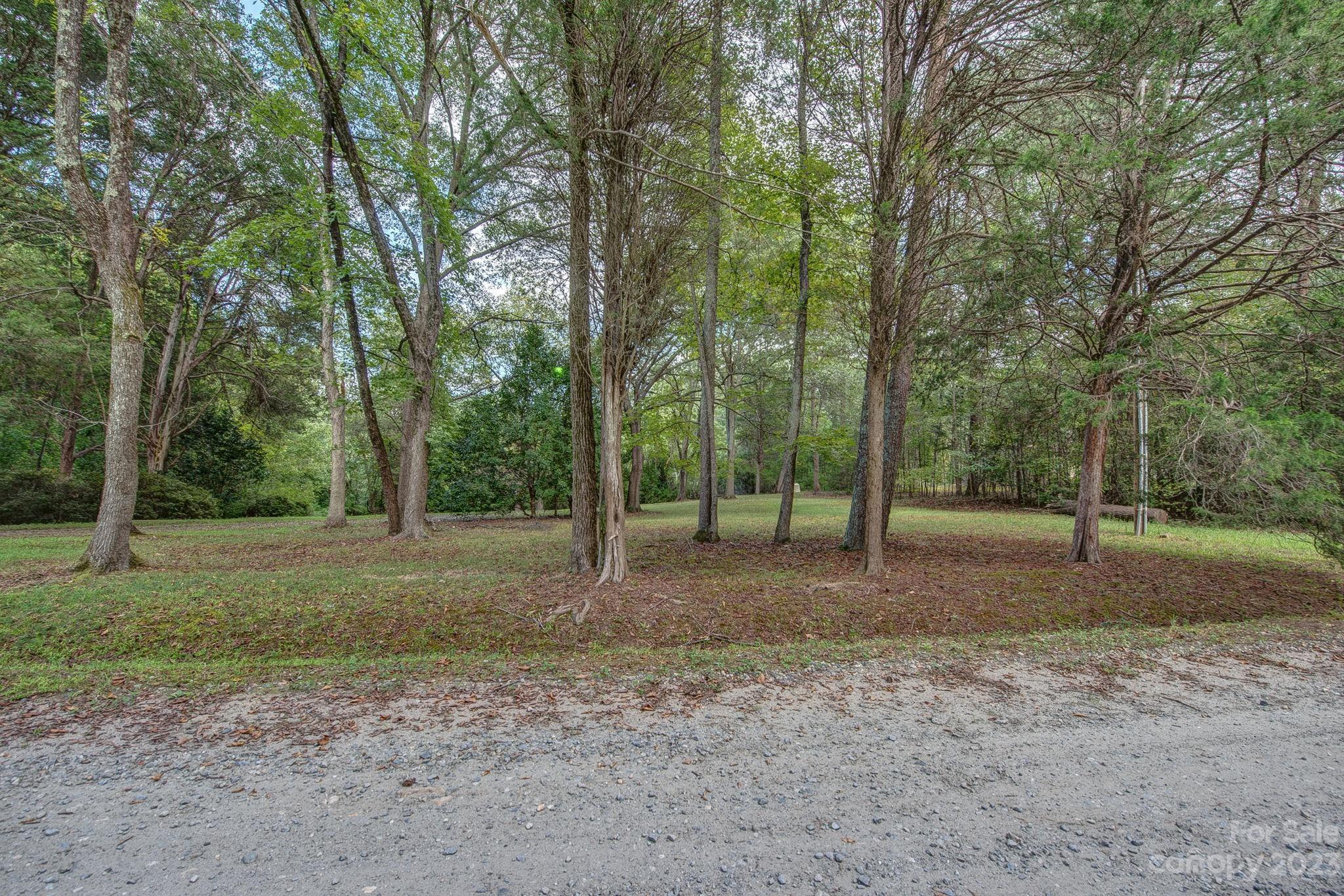 146 Flowers Road Gastonia, NC 28056 - Photo 6 of 11 a view of a forest with trees in the background