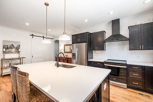 a kitchen with a refrigerator and a stove