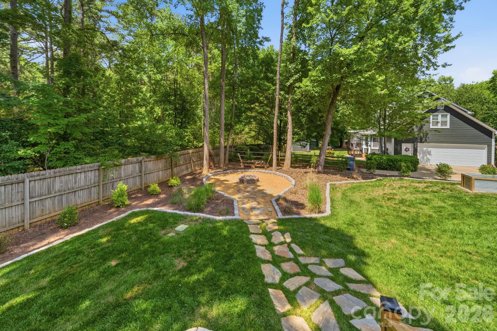 5243 Mintridge Road Mint Hill, NC 28227 - Photo 36 of 43 a view of a park with large trees and a wooden fence