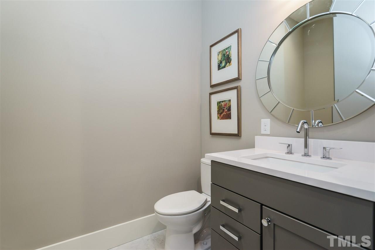 2711 North Mayview Road Raleigh, NC 27607 - Photo 8 of 25 a bathroom with a granite countertop toilet sink and mirror