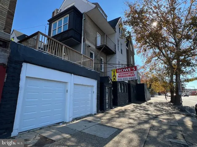 a white toilet sitting next to a white sink and vanity