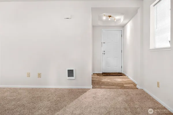 a view of empty room with a fireplace