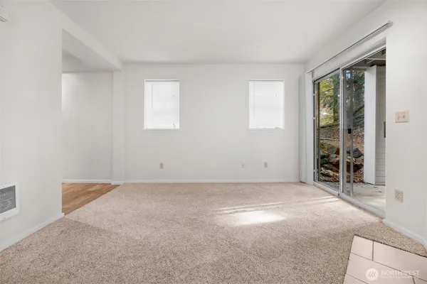 a kitchen with white cabinets and refrigerator