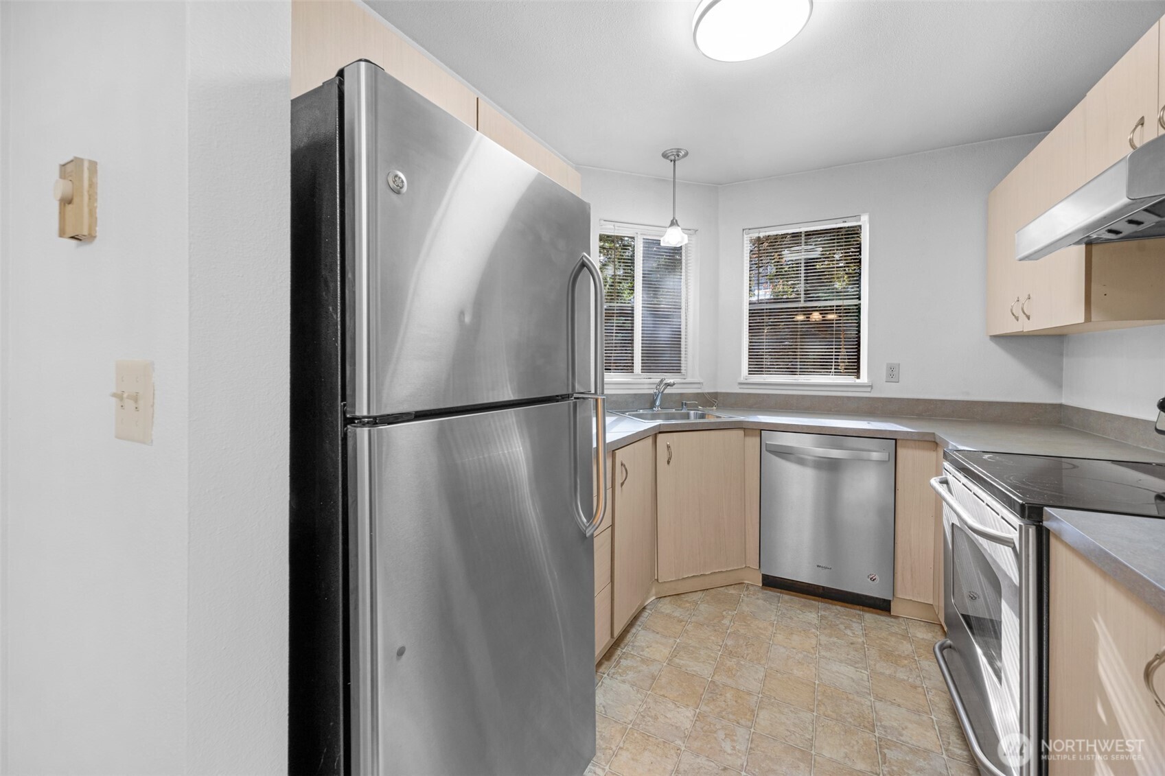 5300 Harbour Pointe Boulevard, Unit 307A Mukilteo, WA 98275 - Photo 10 of 25 a kitchen with white cabinets and refrigerator