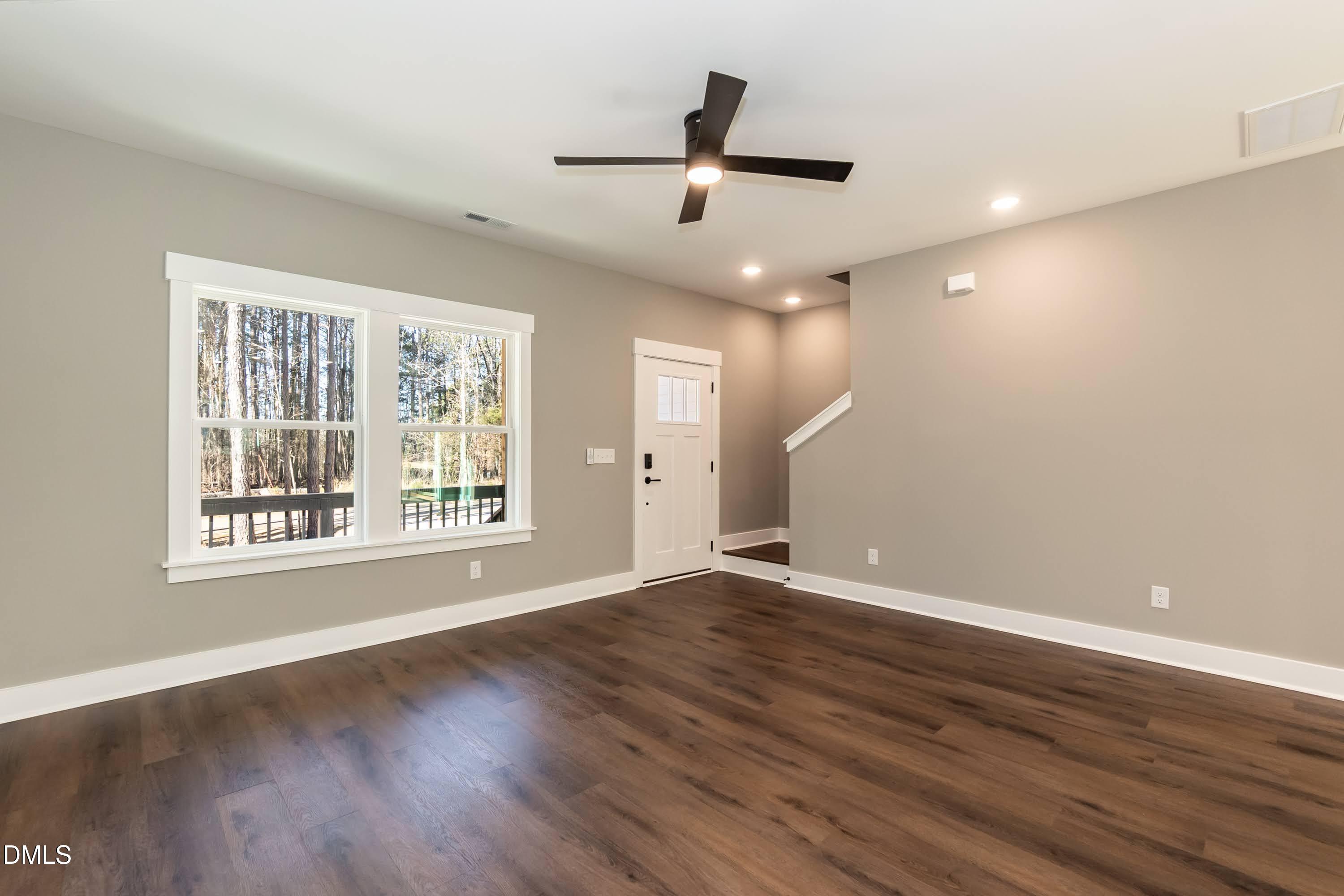 104 Buffalo Drive Spring Hope, NC 27882 - Photo 19 of 48 a view of an empty room with wooden floor and a window
