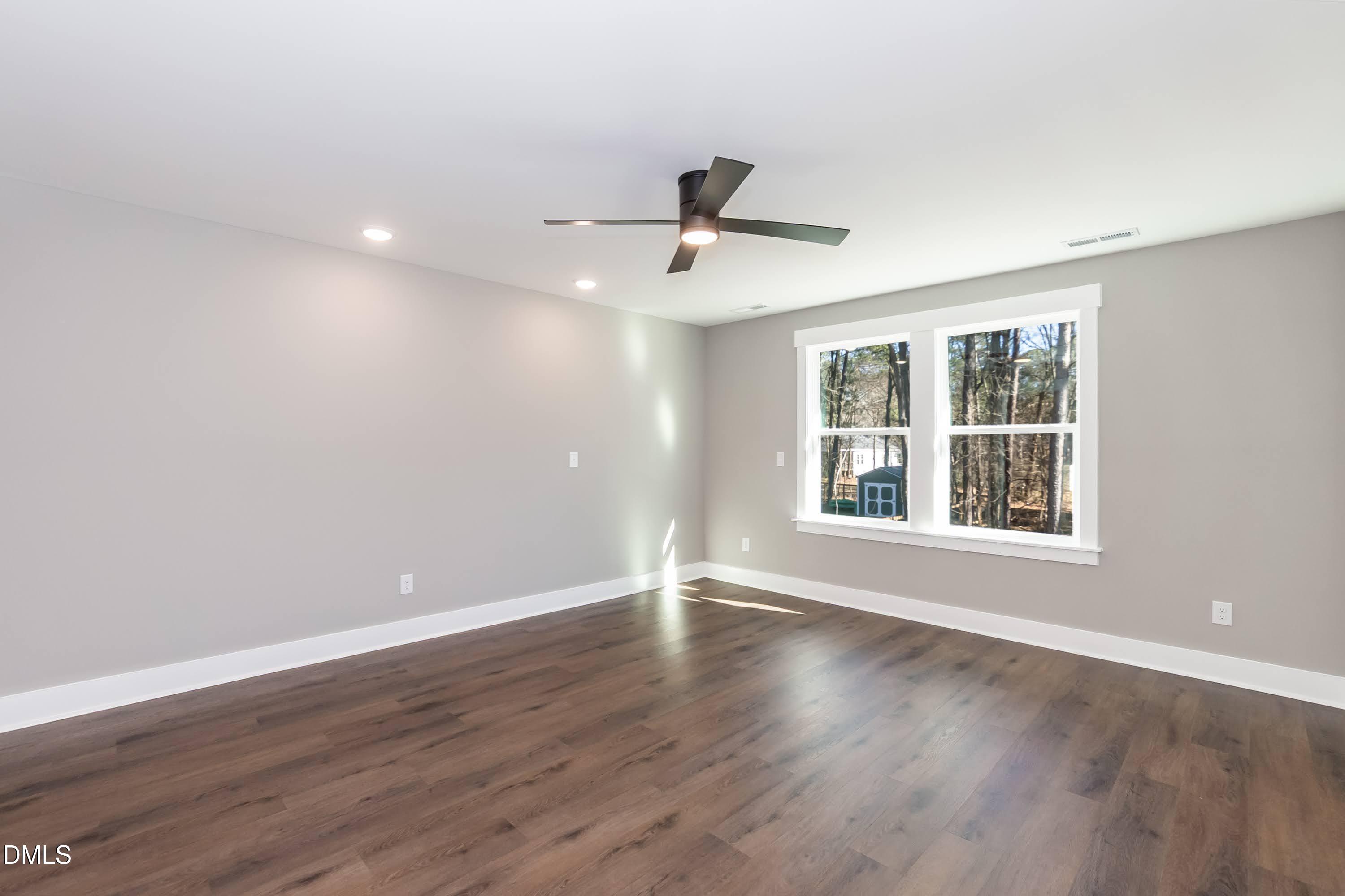 104 Buffalo Drive Spring Hope, NC 27882 - Photo 21 of 48 a view of an empty room with wooden floor and a window