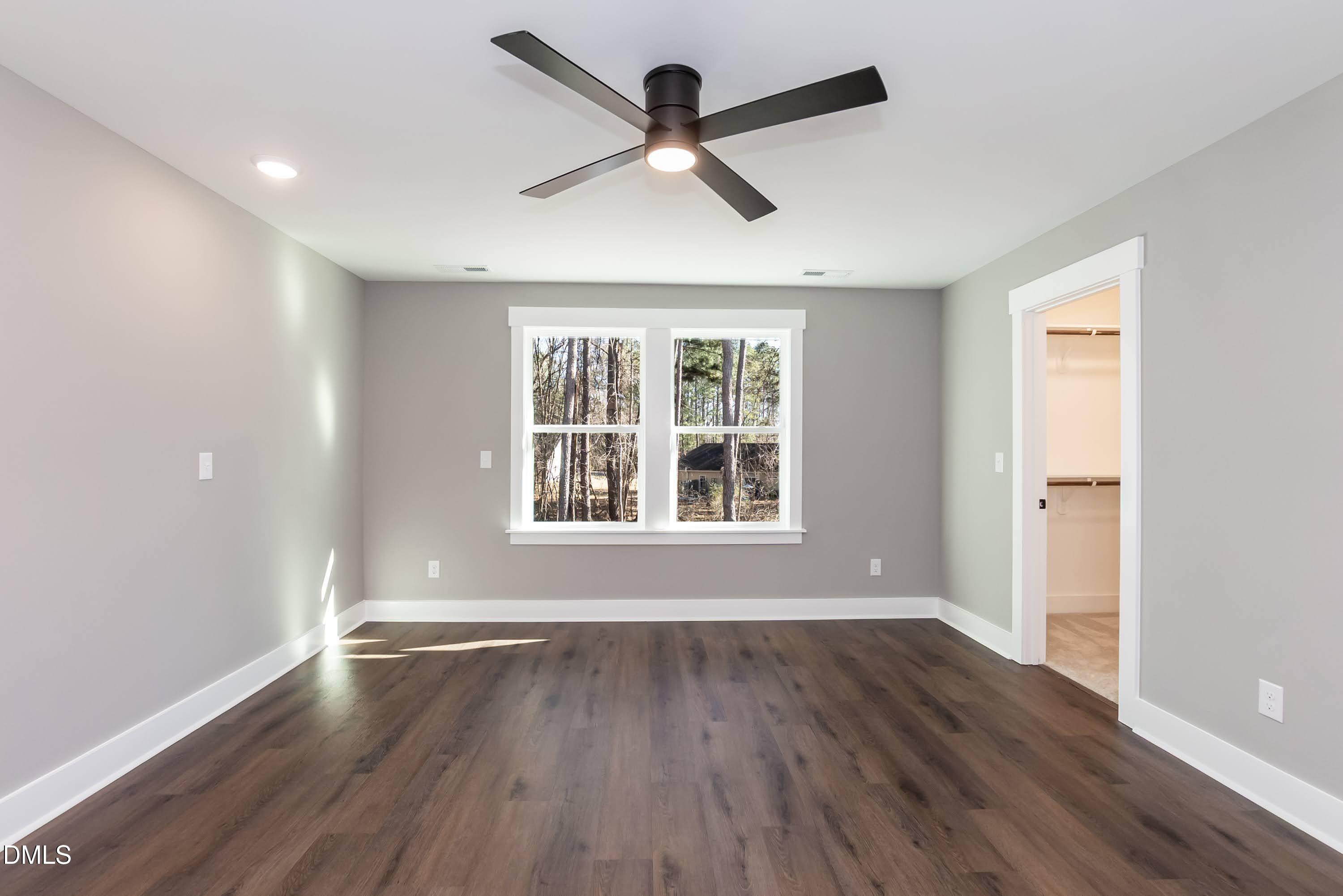 104 Buffalo Drive Spring Hope, NC 27882 - Photo 22 of 48 an empty room with wooden floor and windows