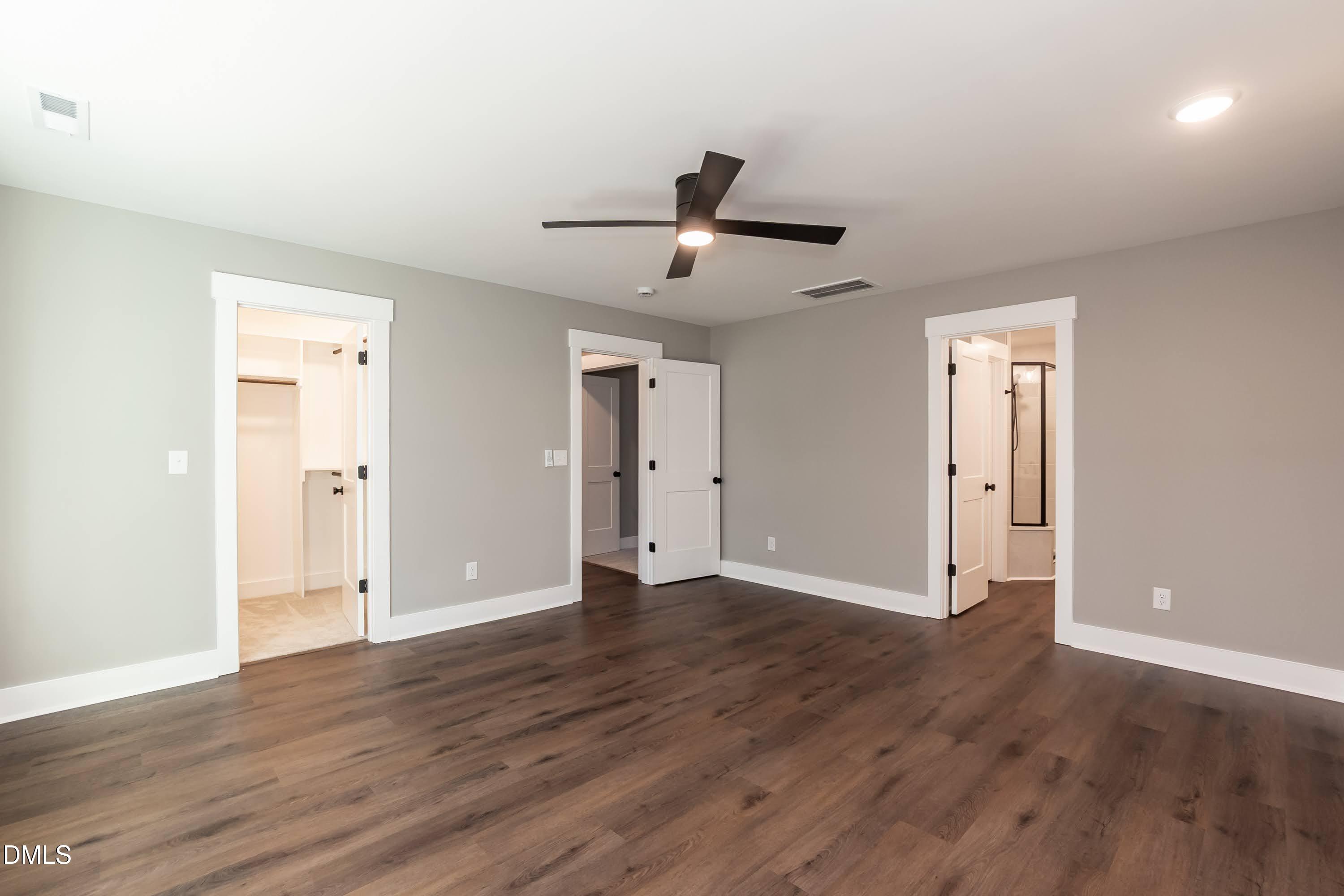 104 Buffalo Drive Spring Hope, NC 27882 - Photo 23 of 48 a view of an empty room with wooden floor and a ceiling fan