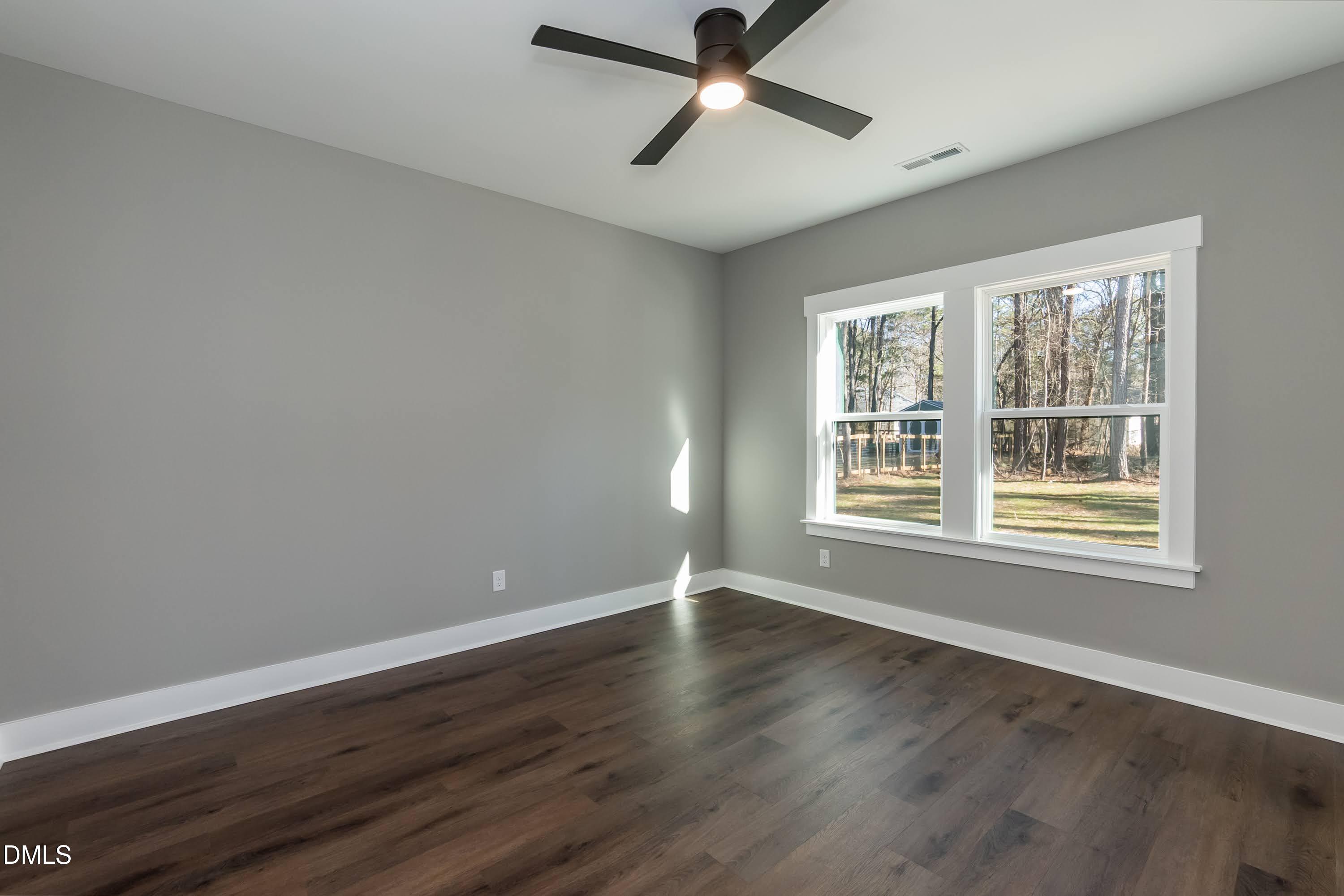 104 Buffalo Drive Spring Hope, NC 27882 - Photo 27 of 48 a view of an empty room with wooden floor and a window