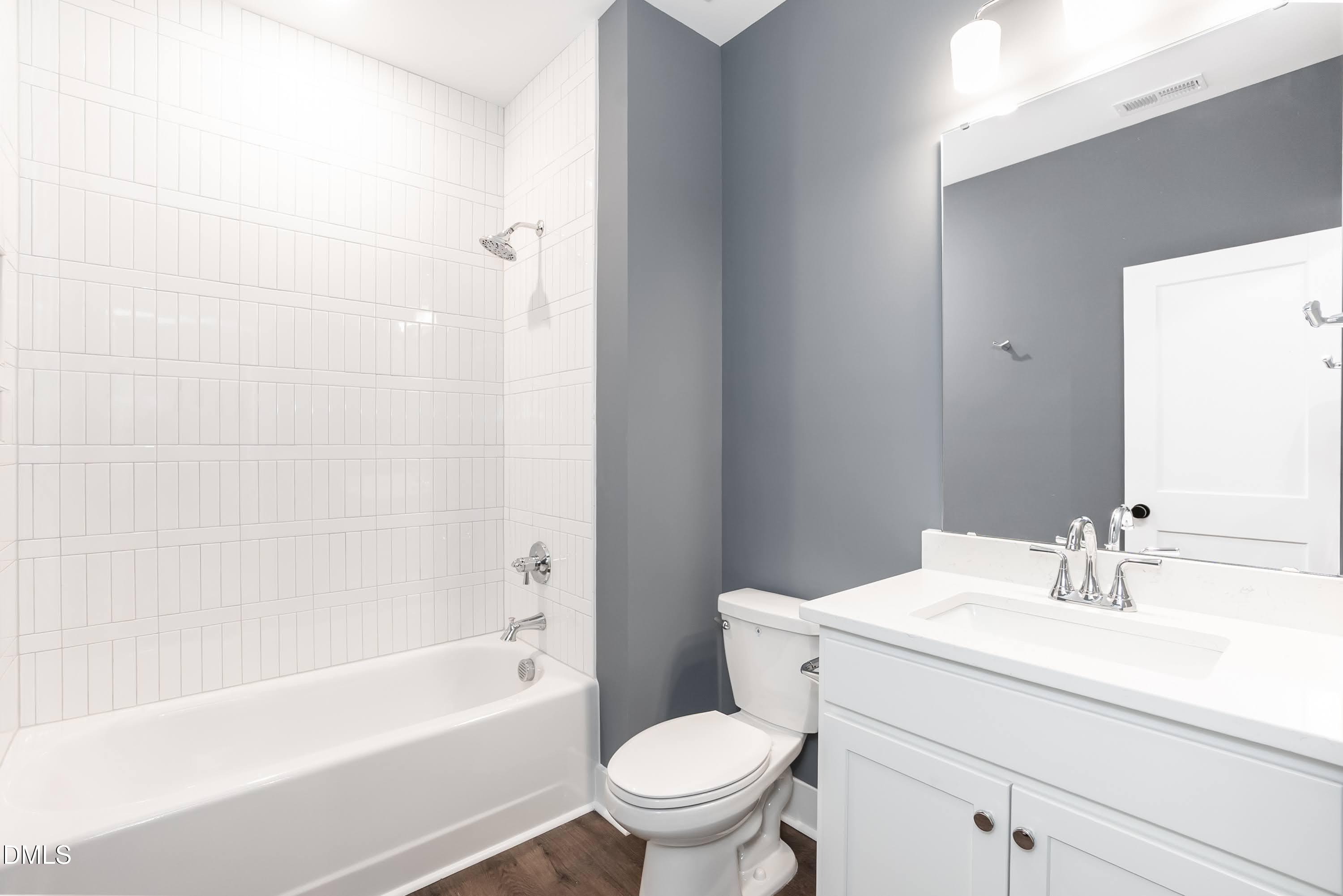 104 Buffalo Drive Spring Hope, NC 27882 - Photo 29 of 48 a bathroom with a sink a toilet and a bathtub