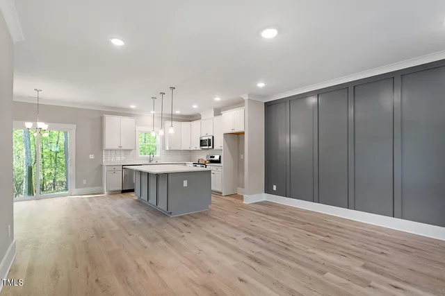 a large kitchen with a lot of counter space and a refrigerator