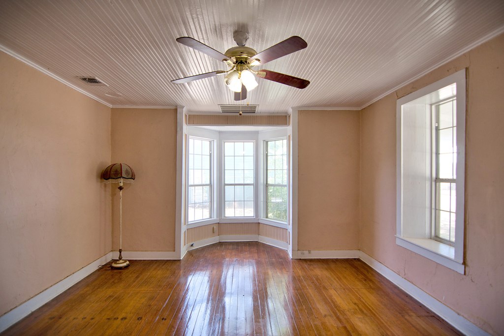 117 Robin Avenue Mason, TX 76856 - Photo 11 of 22 a view of an empty room with a window and wooden floor