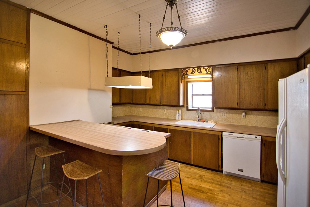 117 Robin Avenue Mason, TX 76856 - Photo 13 of 22 a kitchen with stainless steel appliances granite countertop a sink a stove and a refrigerator