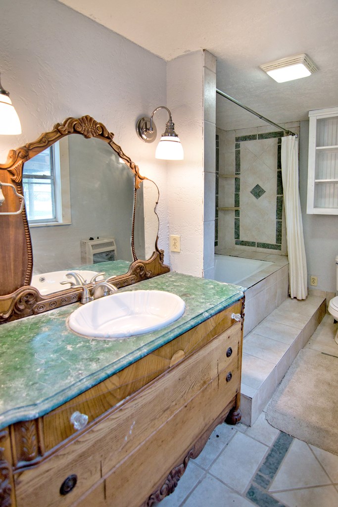 117 Robin Avenue Mason, TX 76856 - Photo 18 of 22 a bathroom with a sink and a mirror