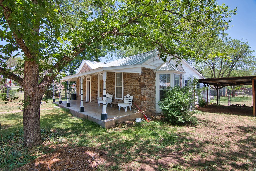 117 Robin Avenue Mason, TX 76856 - Photo 3 of 22 a front view of a house with garden and porch
