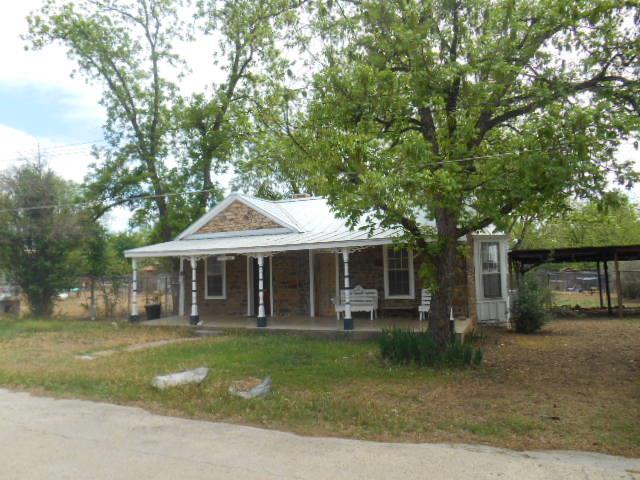 117 Robin Avenue Mason, TX 76856 - Photo 4 of 22 a front view of a house with garden