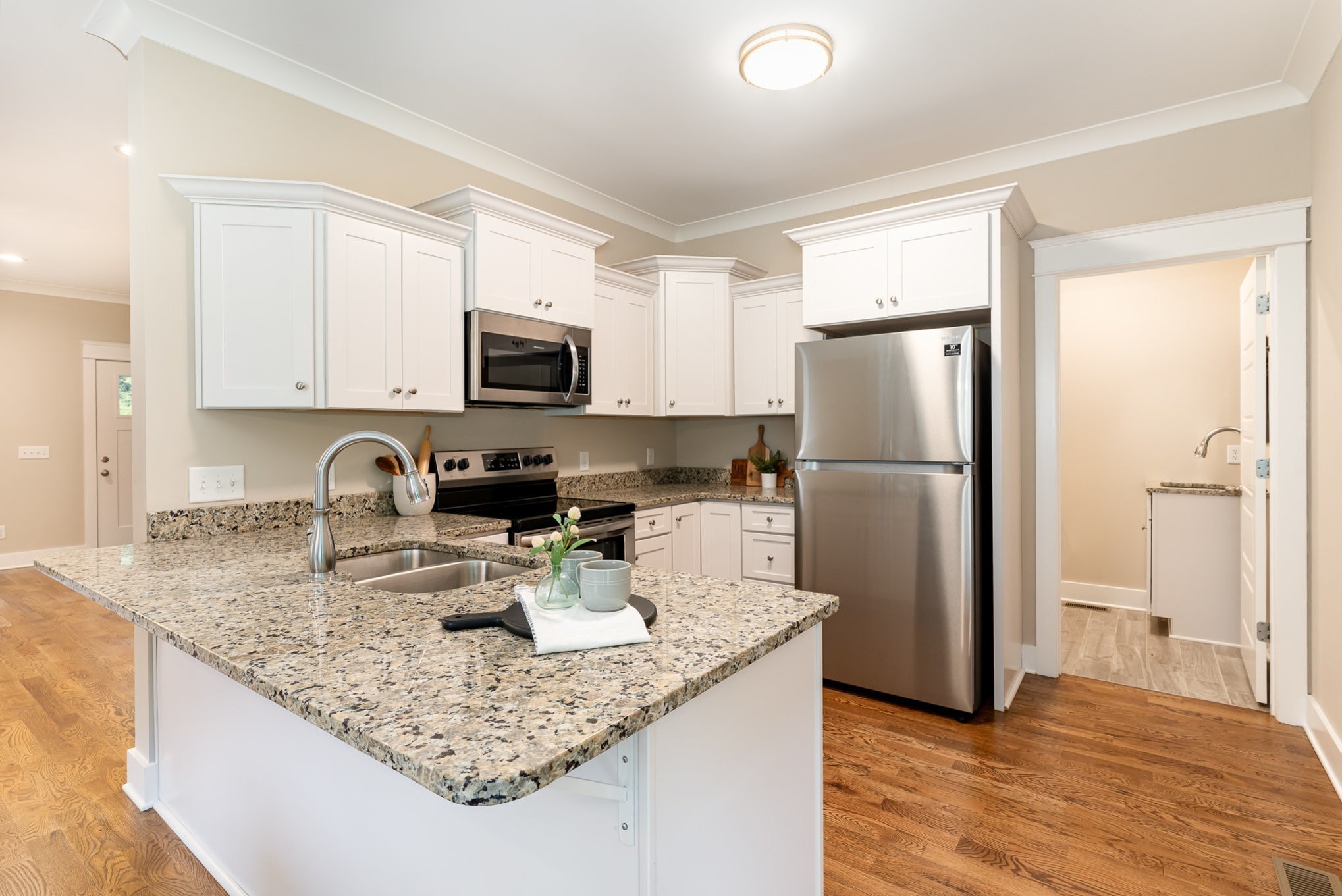 1120 Taylortown Road White Bluff, TN 37187 - Photo 11 of 24 a kitchen with a refrigerator a microwave a sink and cabinets
