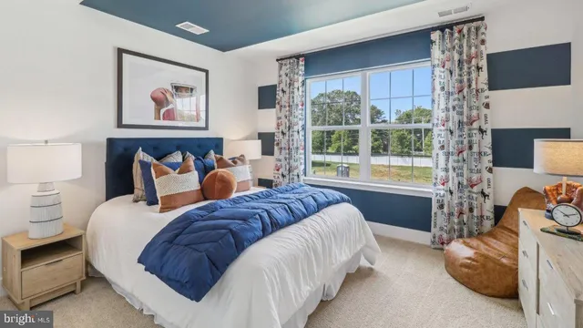 a bed room with a bed and a painting on the wall