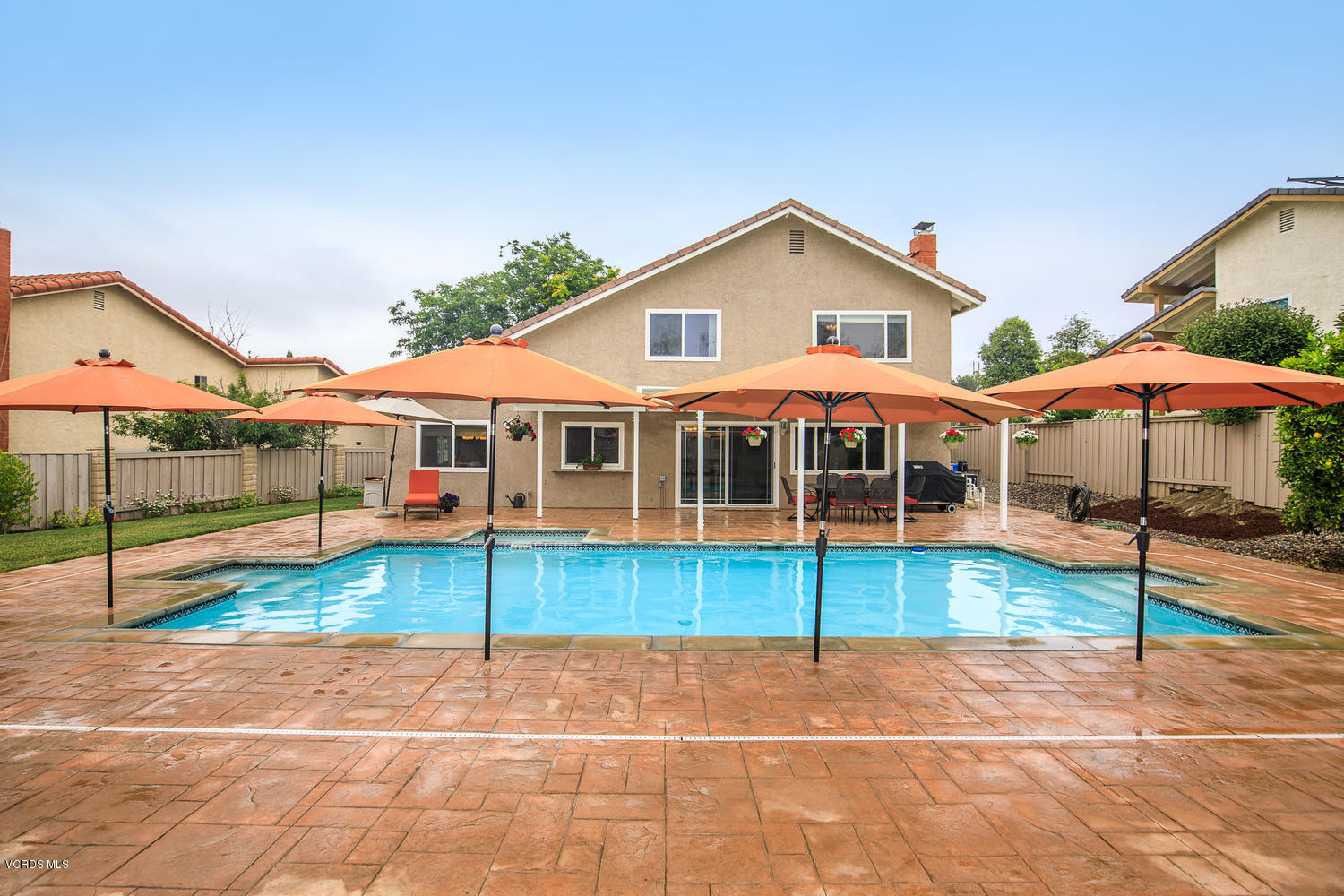 3544 Radcliffe Road Thousand Oaks, CA 91360 - Photo 15 of 27 a view of a white house with a yard and table and chairs