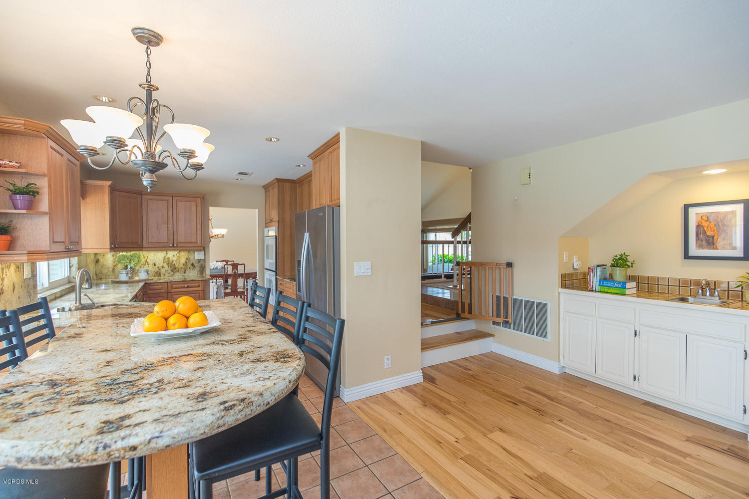 3544 Radcliffe Road Thousand Oaks, CA 91360 - Photo 5 of 27 a bathroom with a granite countertop sink a refrigerator and a wooden floors
