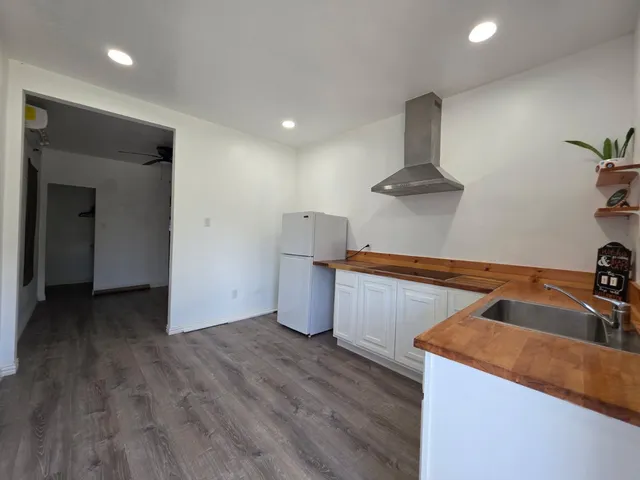 a kitchen that has a sink and a stove in it