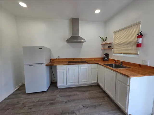 a kitchen with stainless steel appliances granite countertop a sink and a refrigerator