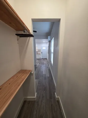 a view of hallway with wooden floor