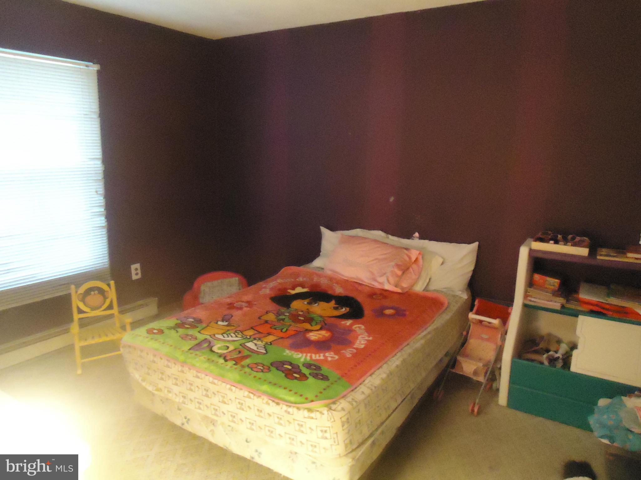 161 Orchard Drive Ranson, WV 25438 - Photo 6 of 9 a bed sitting in a bedroom next to a window