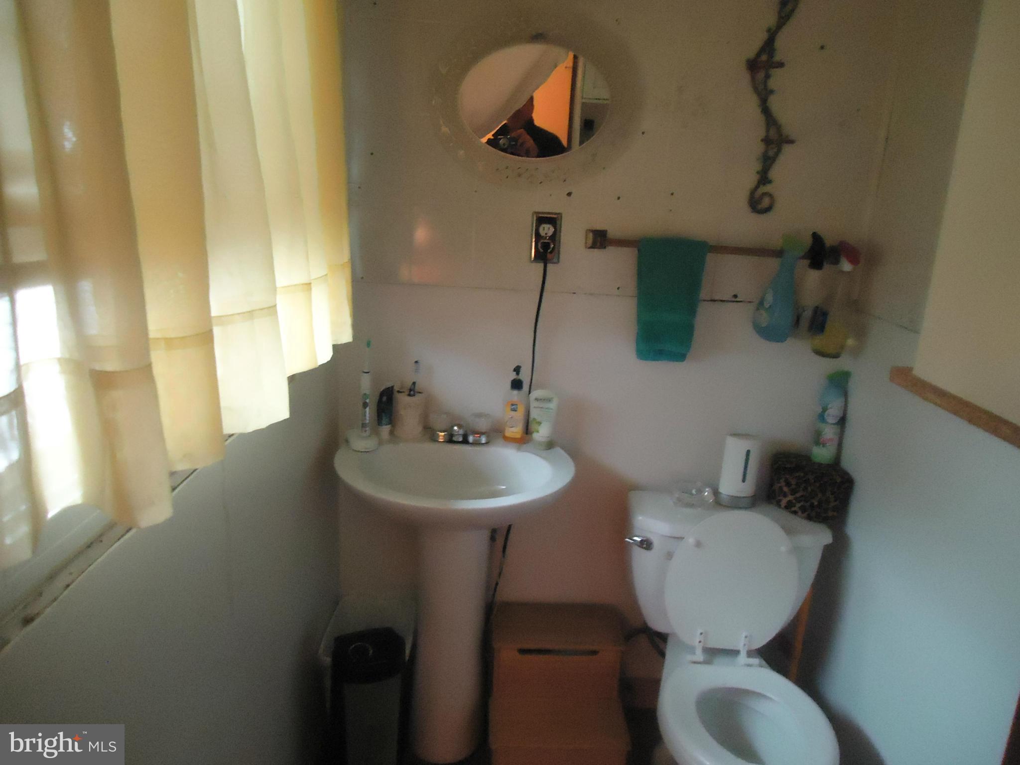 161 Orchard Drive Ranson, WV 25438 - Photo 8 of 9 a bathroom with a toilet sink and mirror