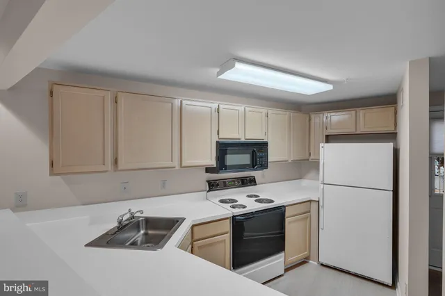 a kitchen with a refrigerator stove and sink