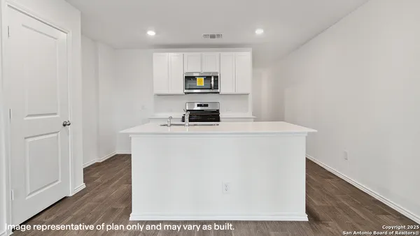 a kitchen that has a sink and a stove