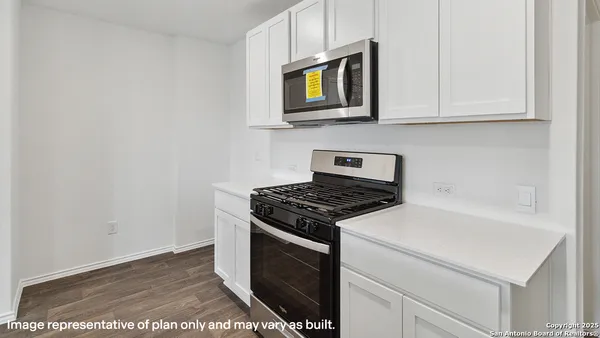 a kitchen that has a sink and a stove