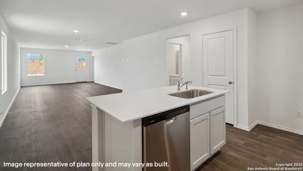 a view of a kitchen with refrigerator and wooden floor
