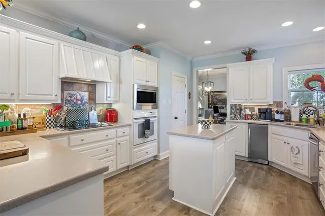 a kitchen with granite countertop white cabinets and white appliances